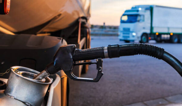 Diesel nozzle from a gas station filling a truck tank.